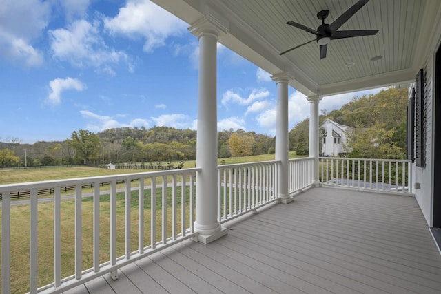 deck featuring a lawn and ceiling fan