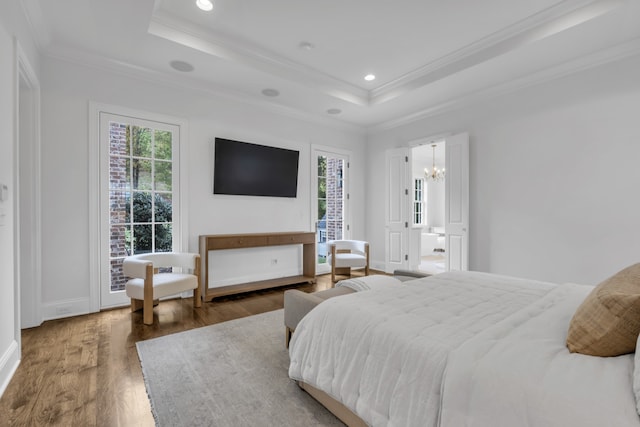 bedroom with crown molding, dark wood-type flooring, multiple windows, and a raised ceiling