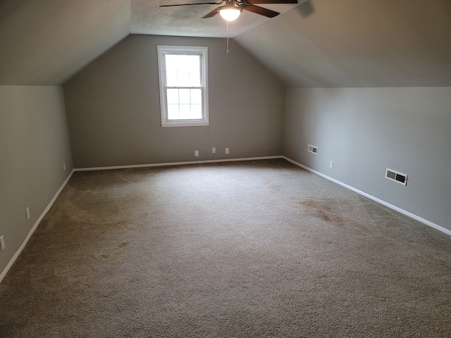 additional living space with lofted ceiling, ceiling fan, and carpet floors