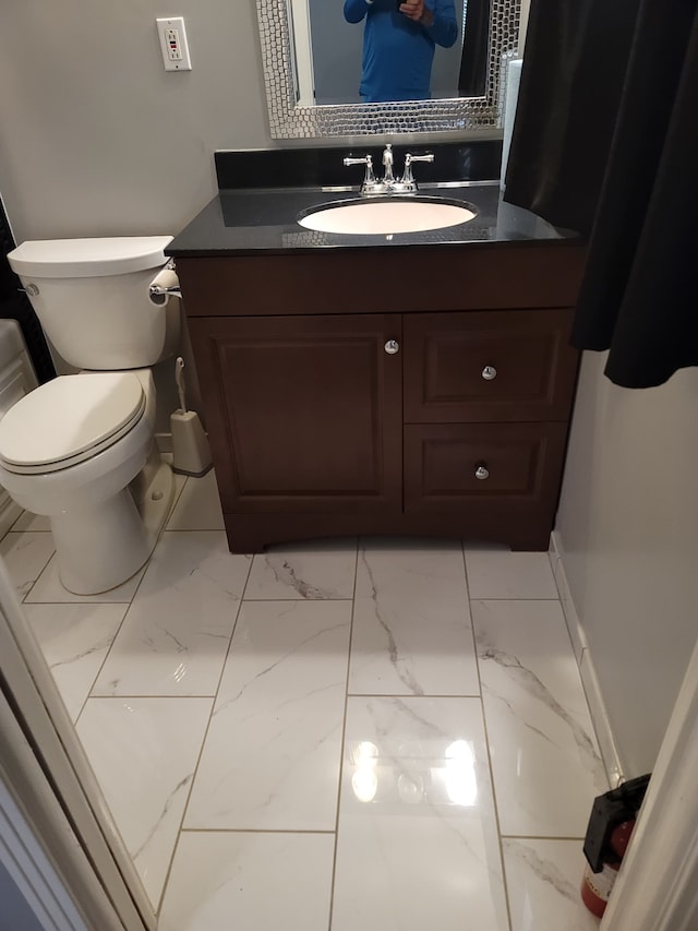 bathroom featuring vanity and toilet