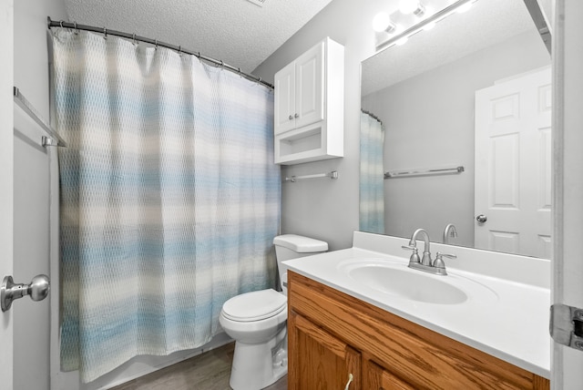 bathroom with hardwood / wood-style flooring, vanity, a textured ceiling, and toilet