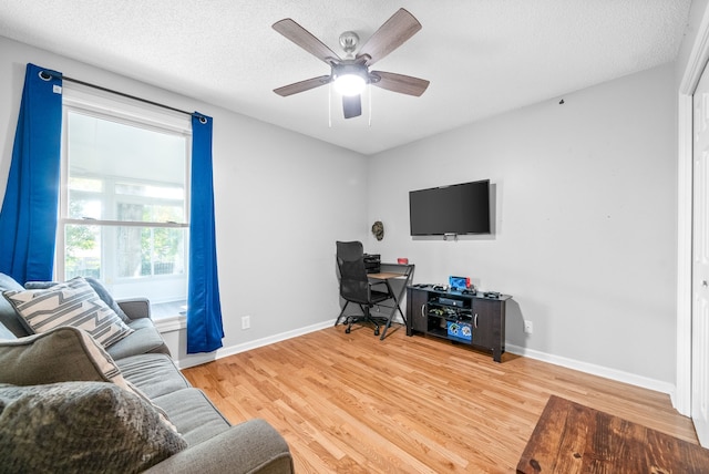 office with wood-type flooring, ceiling fan, and a textured ceiling