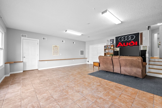 living room featuring a textured ceiling and tile patterned floors