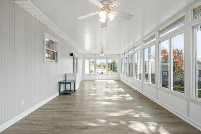 unfurnished sunroom featuring ceiling fan