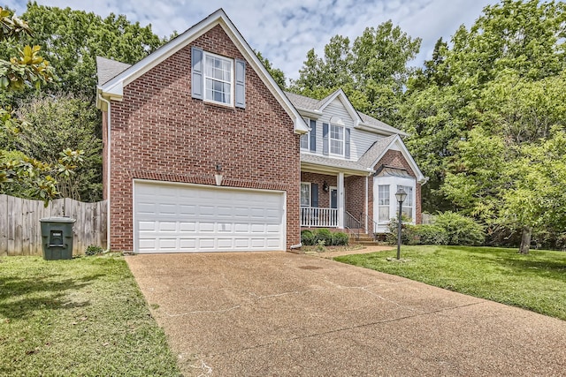 view of front of property featuring a garage, a front lawn, and a porch