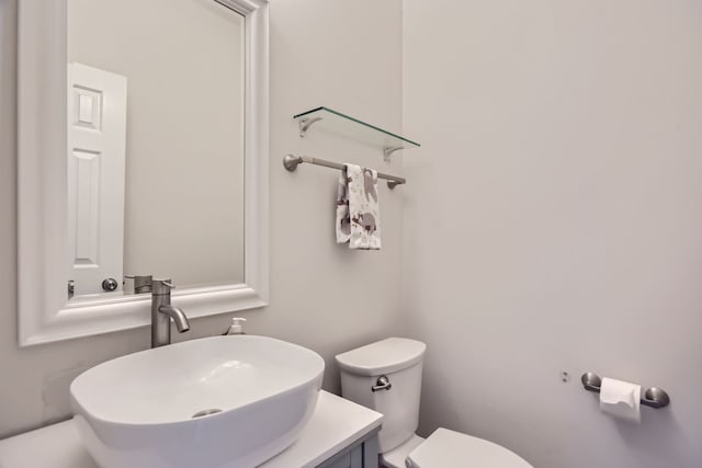 bathroom featuring toilet and vanity