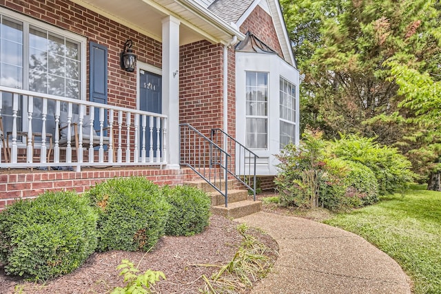 doorway to property featuring covered porch