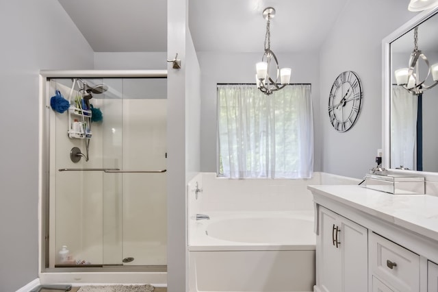 bathroom featuring independent shower and bath, vanity, and a notable chandelier