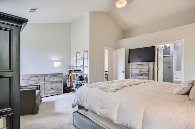 carpeted bedroom featuring ensuite bathroom and high vaulted ceiling