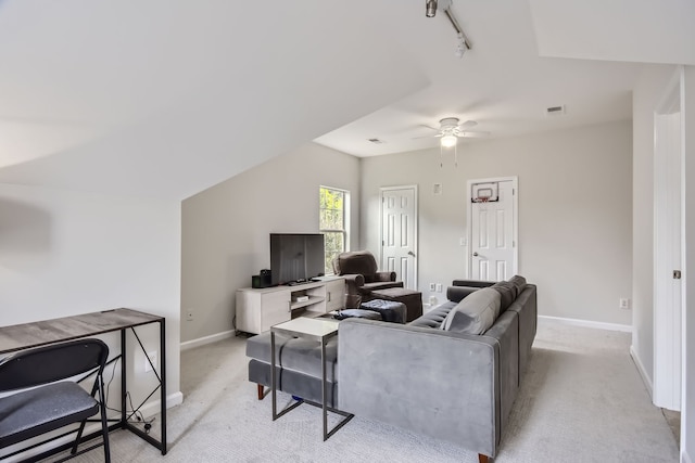 carpeted living room with rail lighting and ceiling fan