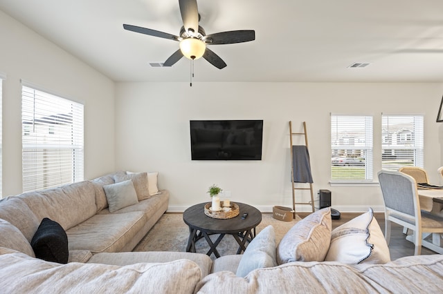 living room featuring a wealth of natural light, ceiling fan, and wood-type flooring