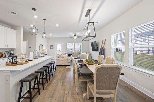 dining area featuring light hardwood / wood-style floors and ceiling fan