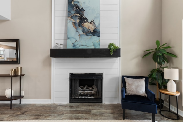 sitting room with dark wood-type flooring