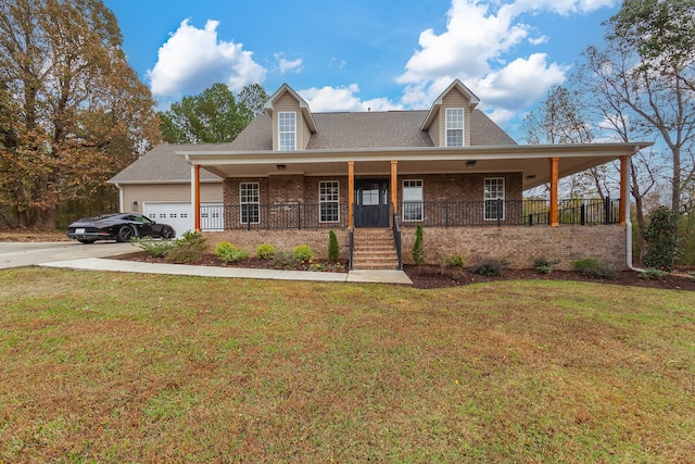 view of front of house featuring a porch, a garage, and a front lawn