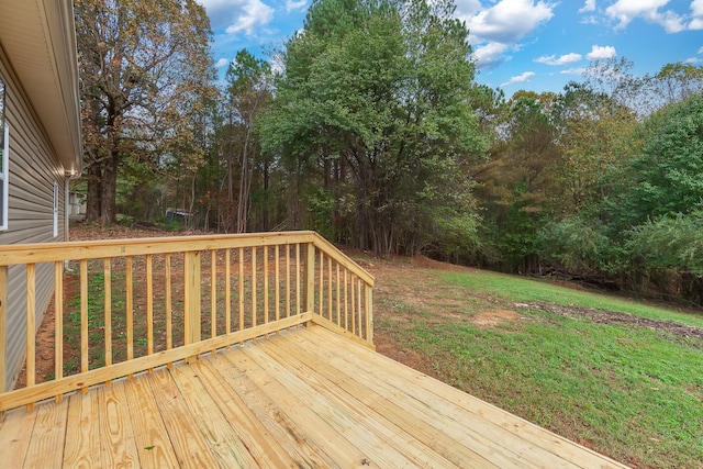 wooden terrace featuring a lawn