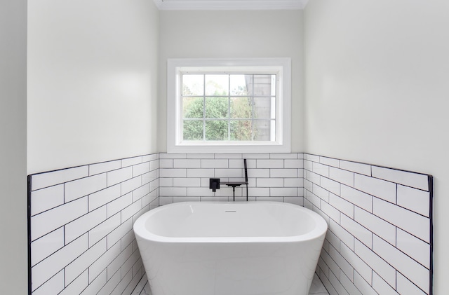 bathroom with tile walls and a tub to relax in