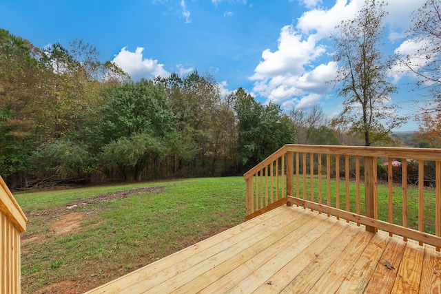 wooden terrace featuring a lawn