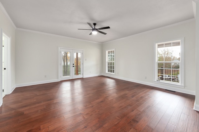 spare room featuring ornamental molding, plenty of natural light, dark hardwood / wood-style flooring, and french doors