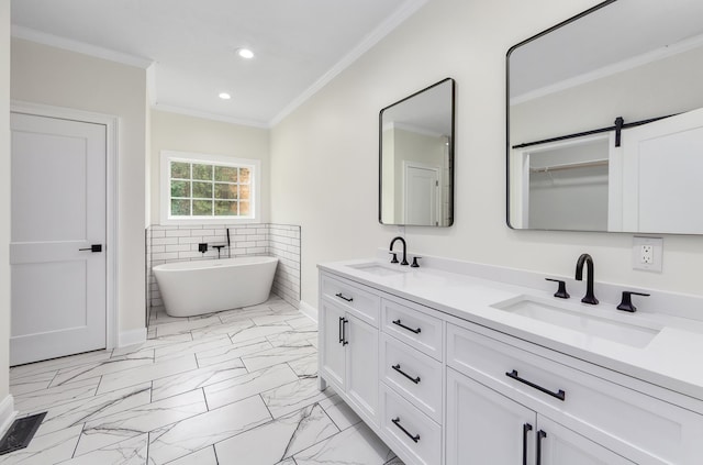 bathroom featuring crown molding, vanity, and a bathing tub