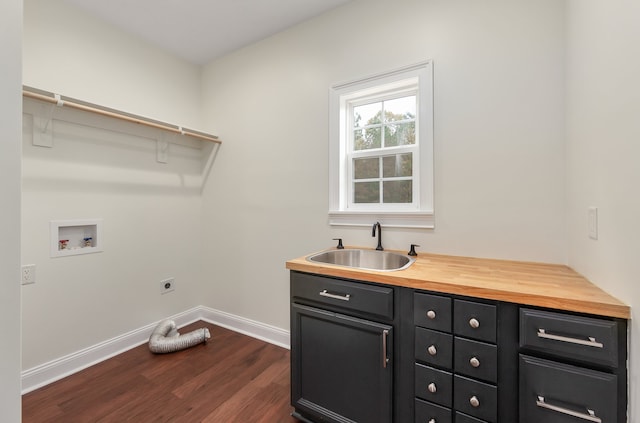 laundry area with sink, dark hardwood / wood-style flooring, cabinets, washer hookup, and electric dryer hookup