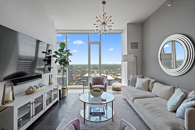 living room featuring a wealth of natural light, a notable chandelier, floor to ceiling windows, and dark hardwood / wood-style flooring