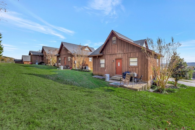 rear view of property with a patio area and a lawn