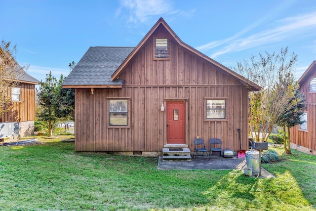 rear view of house featuring a yard