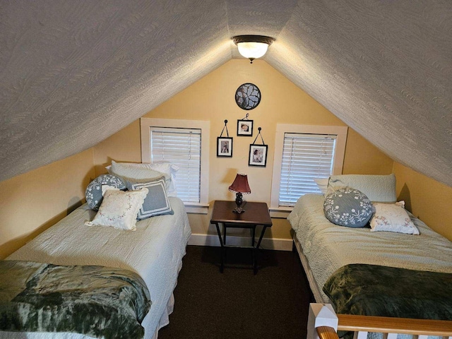 bedroom with lofted ceiling and a textured ceiling