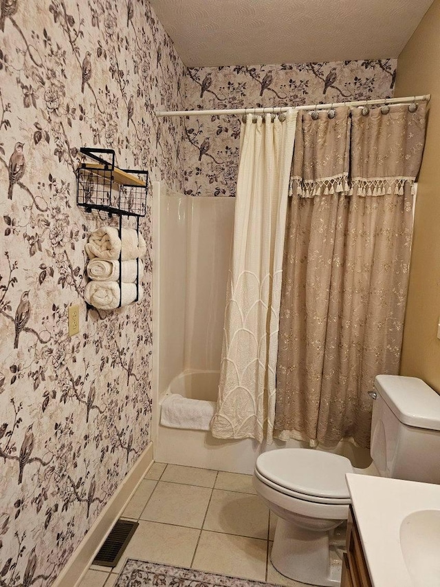 full bathroom featuring tile patterned floors, toilet, a textured ceiling, vanity, and shower / bath combo