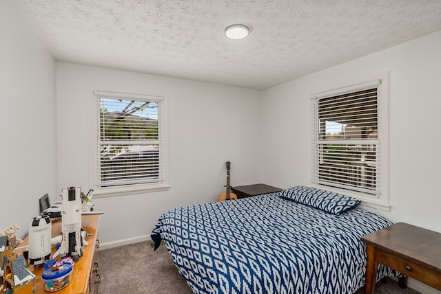 carpeted bedroom with a textured ceiling