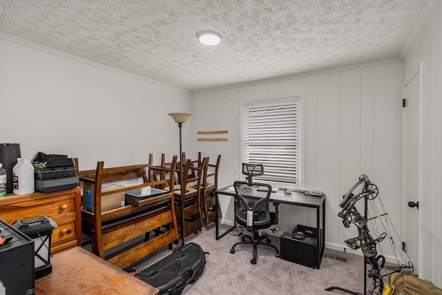 carpeted office space featuring a textured ceiling and ornamental molding