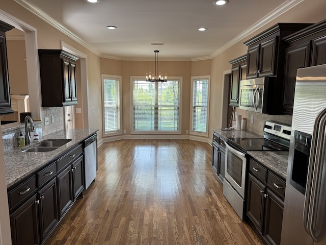 kitchen featuring dark hardwood / wood-style flooring, backsplash, appliances with stainless steel finishes, and sink