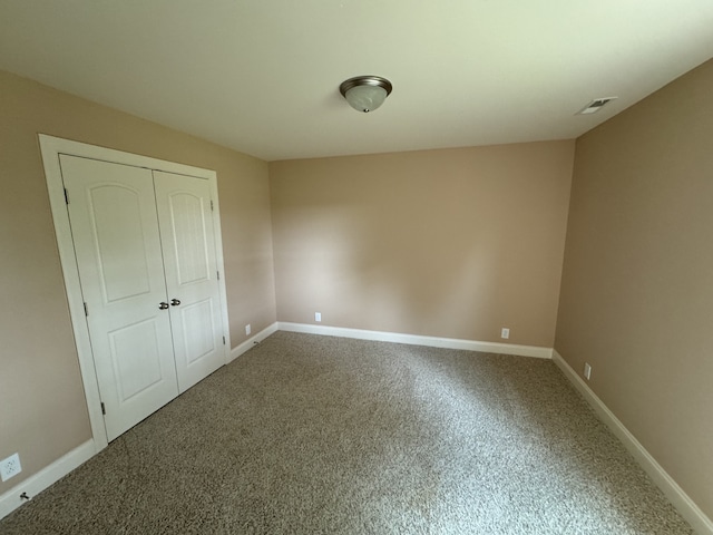 unfurnished bedroom with carpet and a closet