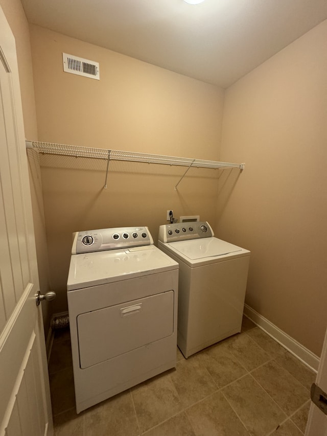 laundry area featuring light tile patterned flooring and washer and dryer