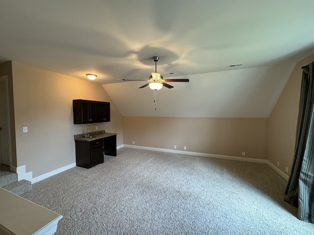 bonus room featuring vaulted ceiling, light colored carpet, and ceiling fan