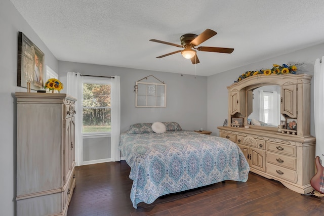 bedroom featuring ceiling fan, dark hardwood / wood-style flooring, and a textured ceiling