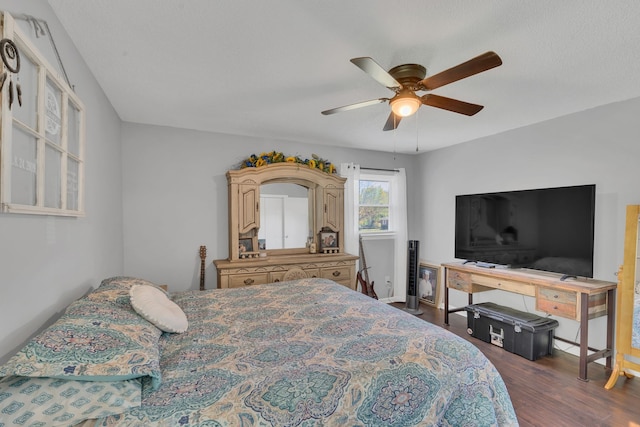 bedroom with ceiling fan and dark wood-type flooring