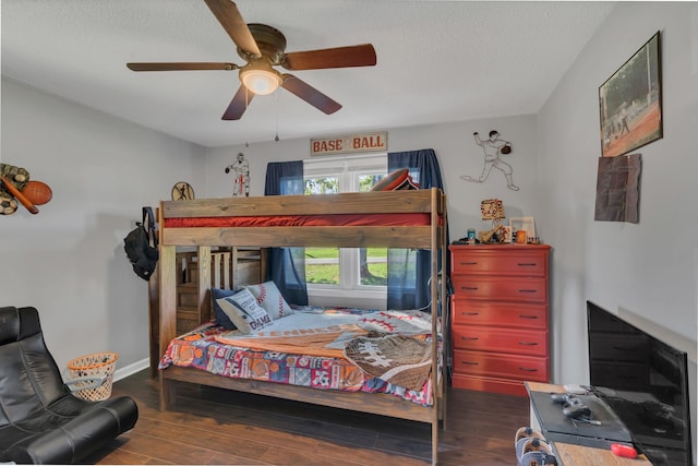 bedroom featuring a textured ceiling, dark hardwood / wood-style floors, and ceiling fan