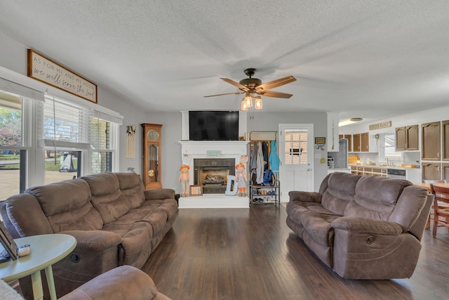 living room featuring a wealth of natural light, sink, ceiling fan, and dark hardwood / wood-style floors