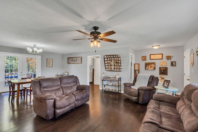 living room with a textured ceiling, french doors, ceiling fan with notable chandelier, and dark hardwood / wood-style floors