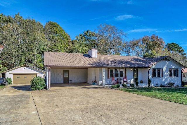 ranch-style home featuring a front lawn, an outdoor structure, a carport, covered porch, and a garage