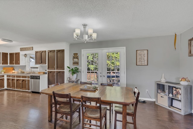 dining room with a textured ceiling, french doors, dark hardwood / wood-style floors, and an inviting chandelier