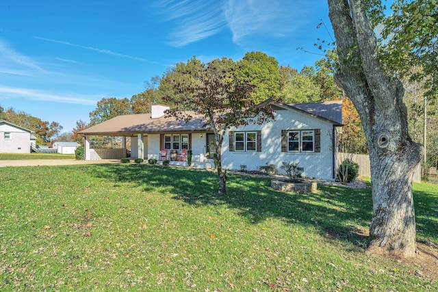 single story home featuring a front yard and covered porch