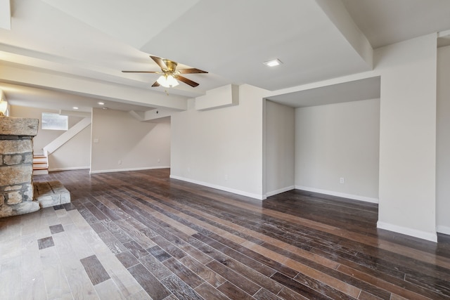 unfurnished living room with dark hardwood / wood-style floors and ceiling fan