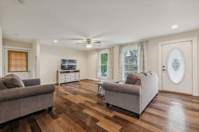 living room featuring dark hardwood / wood-style floors and ceiling fan