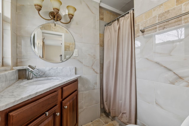 bathroom featuring vanity and tile walls