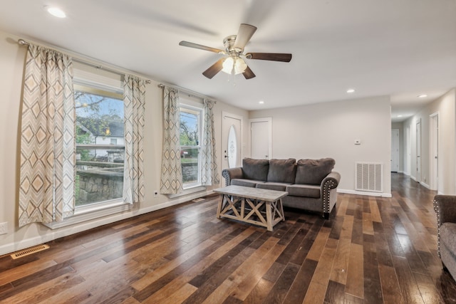 living room with dark hardwood / wood-style floors and ceiling fan