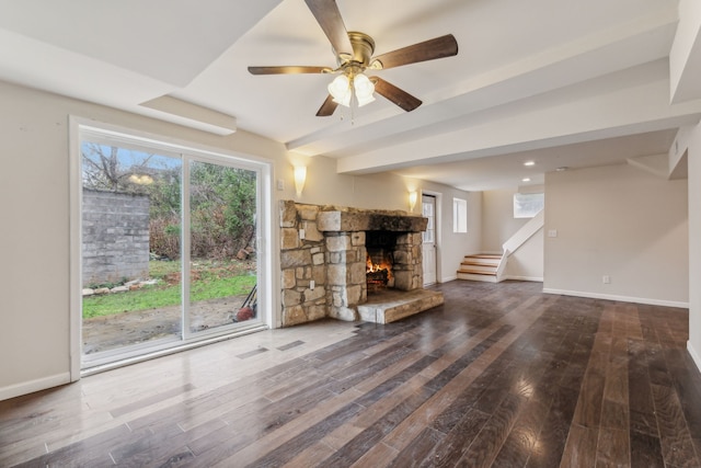 unfurnished living room with a fireplace, wood-type flooring, and ceiling fan