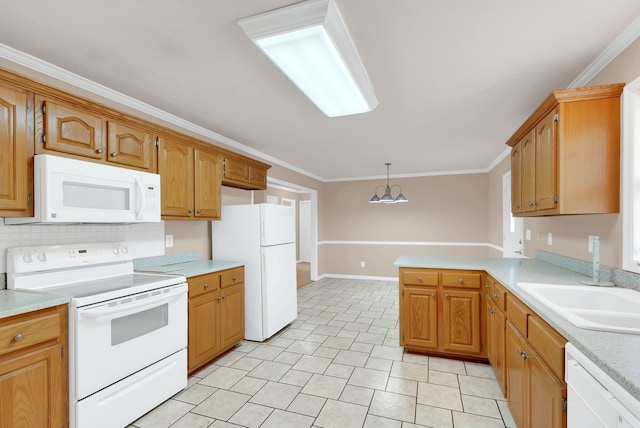 kitchen with an inviting chandelier, kitchen peninsula, ornamental molding, pendant lighting, and white appliances