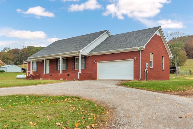 ranch-style home featuring a garage and a front yard